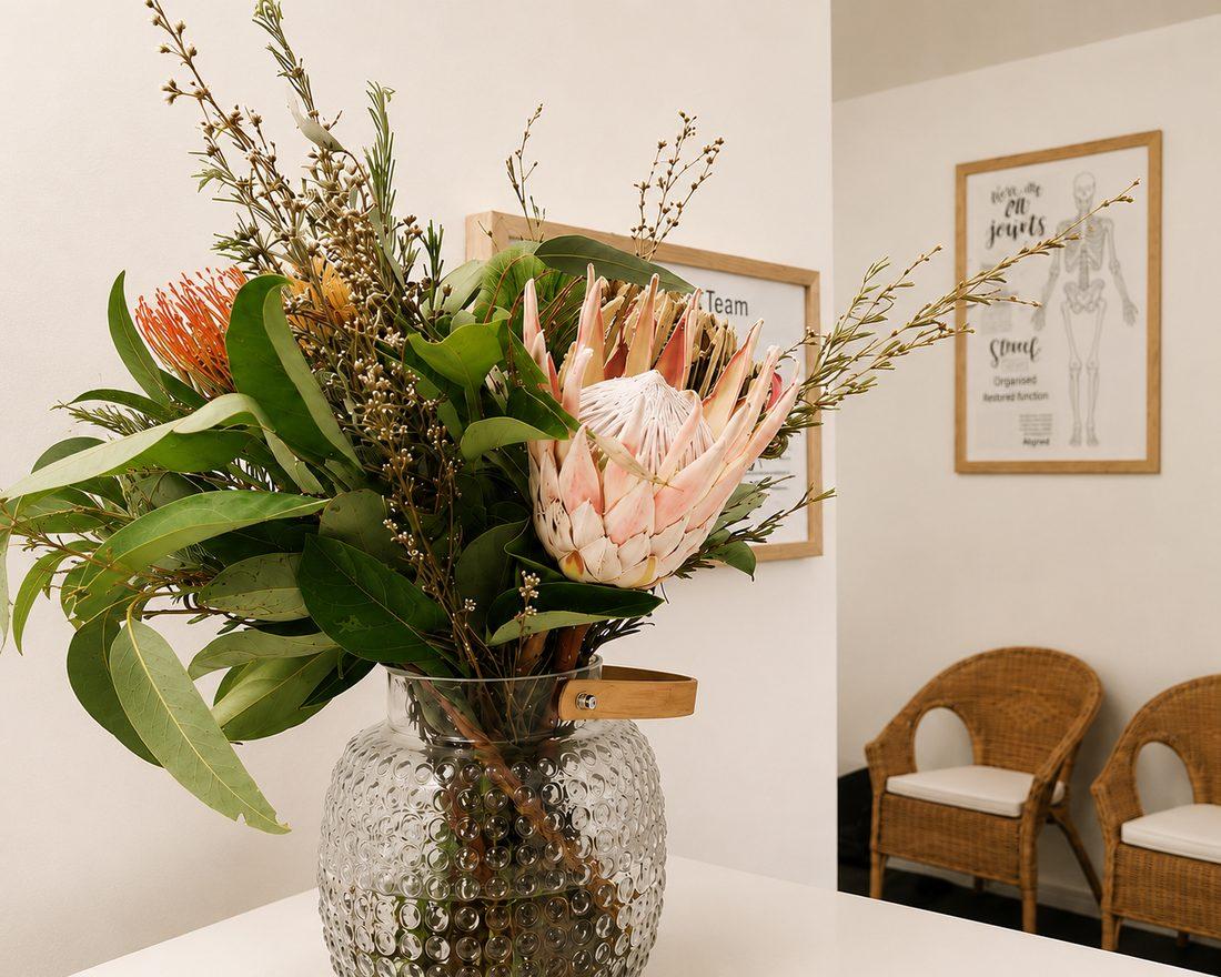 Pink king protea in a glass vase — our reception nook